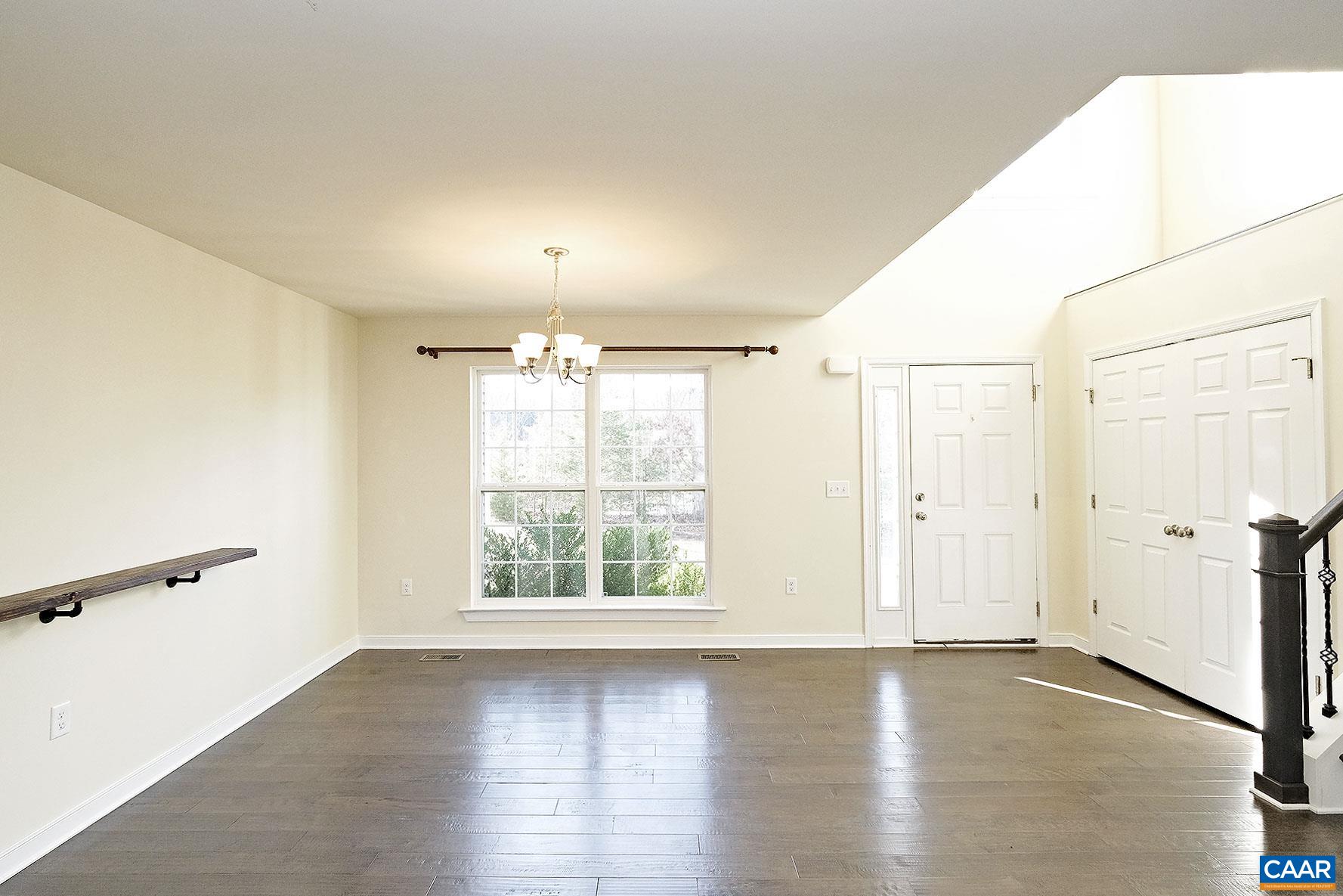 115 Reedy Creek Road Louisa, VA 23093 - Photo 2 of 17 an empty room with wooden floor and windows