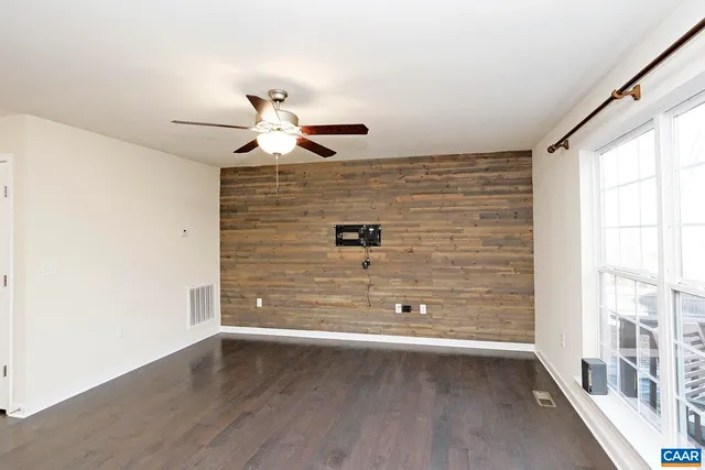 a view of a ceiling fan and wooden floor