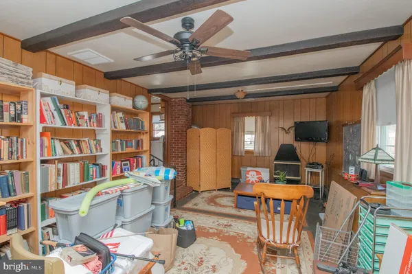 a living room with furniture and a book shelf