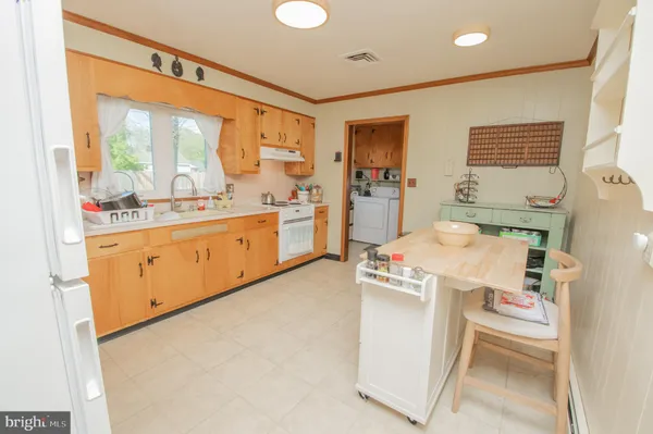 a utility room with cabinets washer and dryer