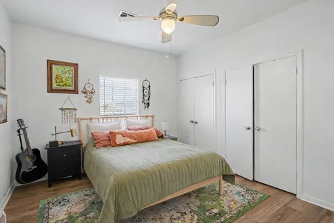 a bedroom with a bed and wooden floor