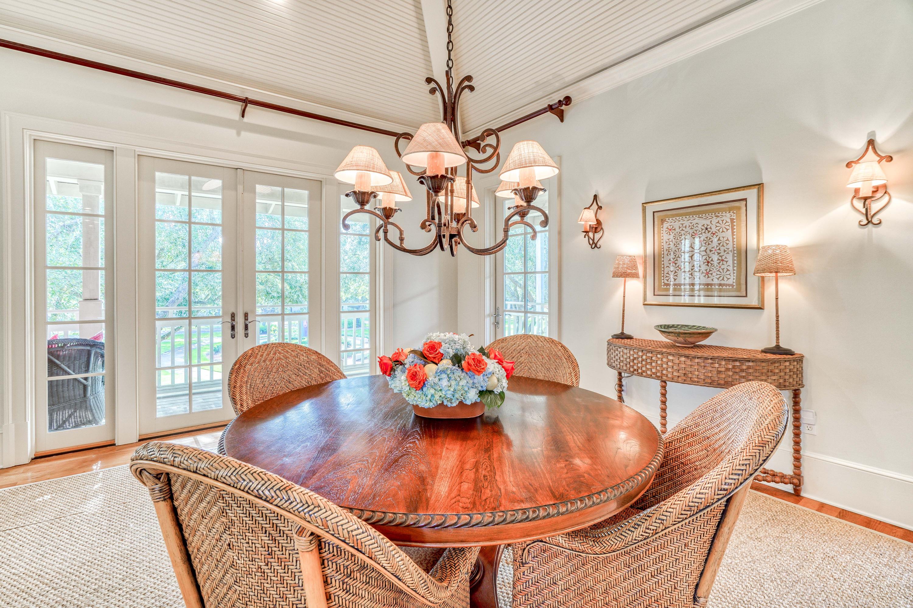 113 East Long Green Road Rosemary Beach, FL 32461 - Photo 38 of 54 a dining room with wooden floor a chandelier a glass table and chairs