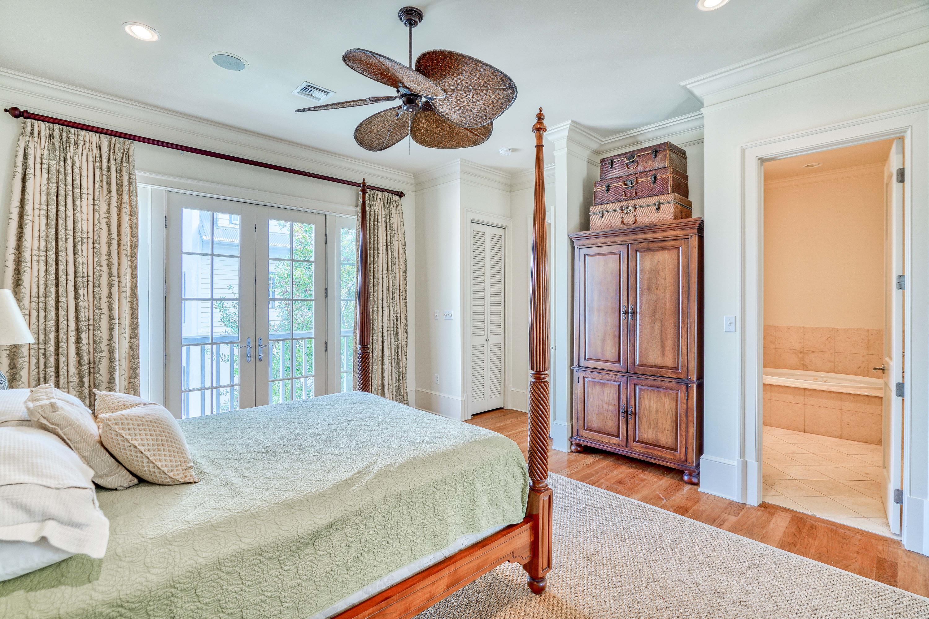 113 East Long Green Road Rosemary Beach, FL 32461 - Photo 42 of 54 a bedroom with a large bed and a chandelier