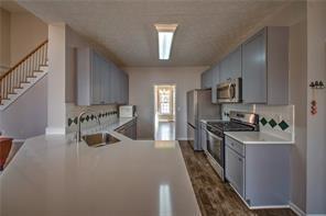 2234 Oak Falls Lane Buford, GA 30519 - Photo 5 of 23 a kitchen with sink a stove and cabinets