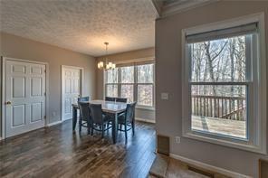 2234 Oak Falls Lane Buford, GA 30519 - Photo 7 of 23 a view of a dining room with furniture window and wooden floor
