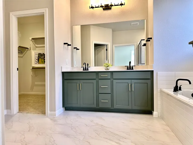 a spacious bathroom with a mirror sink and vanity