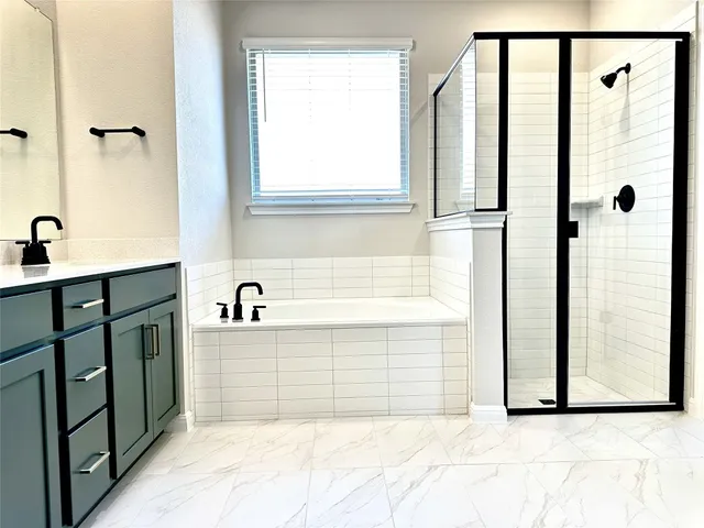 a bathroom with a bathtub and a shower