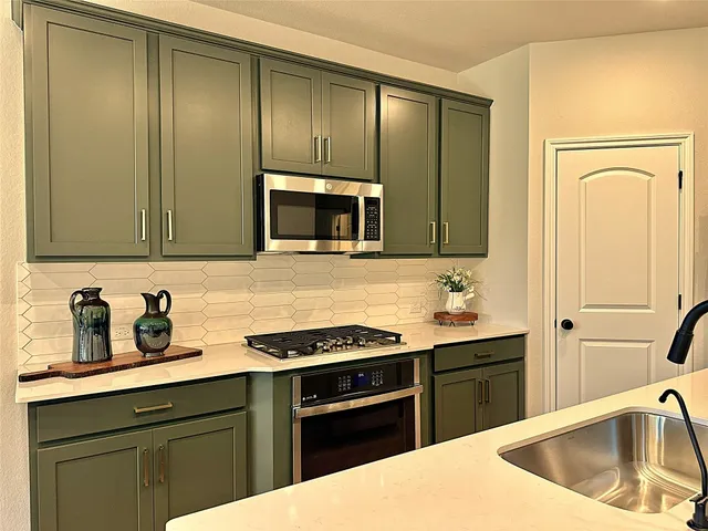 a kitchen with a sink stove and refrigerator