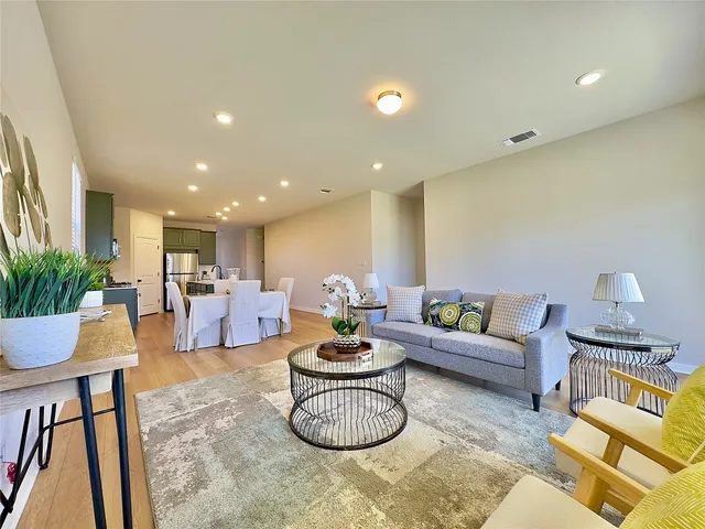 a living room with furniture a rug and a potted plant