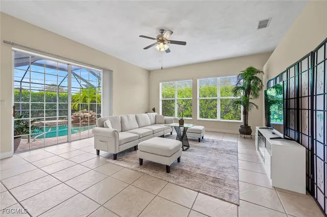 a living room with furniture and large windows