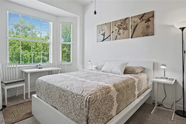 a bedroom with a large bed and a window