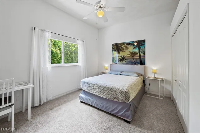 a bedroom with a bed a chandelier and window
