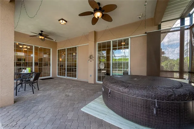 a living room with couch a dining table and a large window