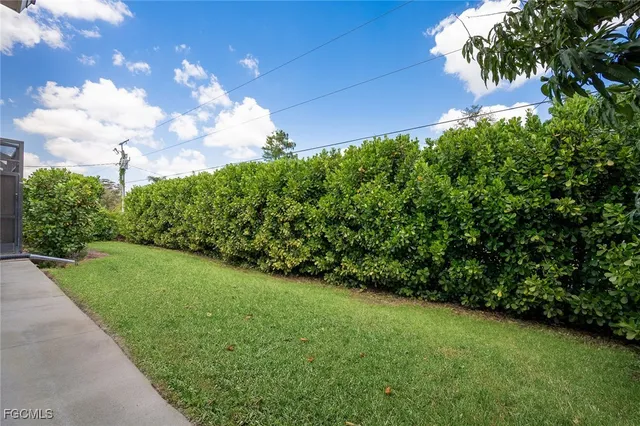 a view of a yard with yellow house