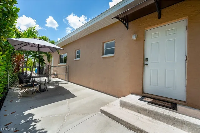 a balcony with furniture and a potted plant