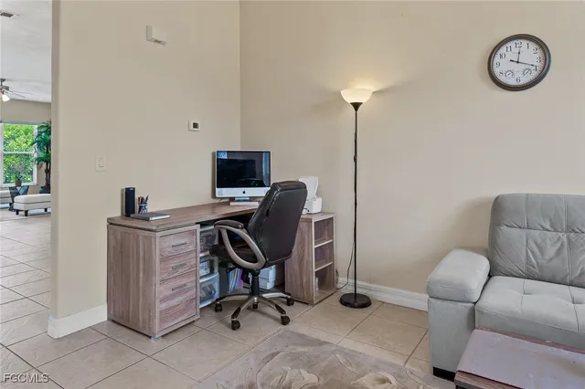 a view of a workspace with furniture and a window