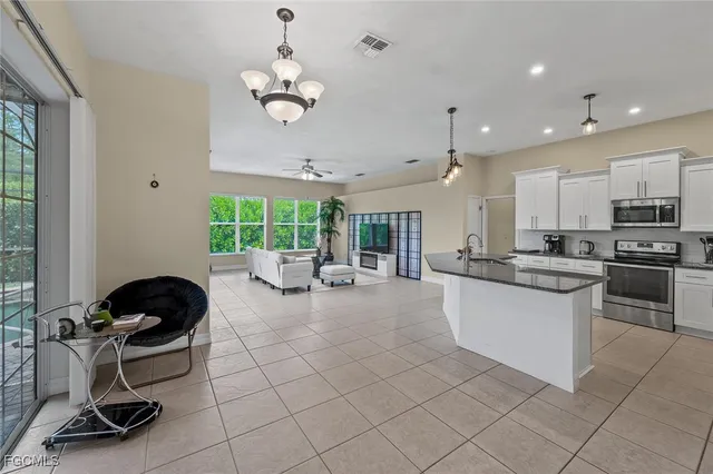 a kitchen with stainless steel appliances granite countertop a stove and a sink