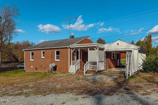 a view of a house with swimming pool and sitting area