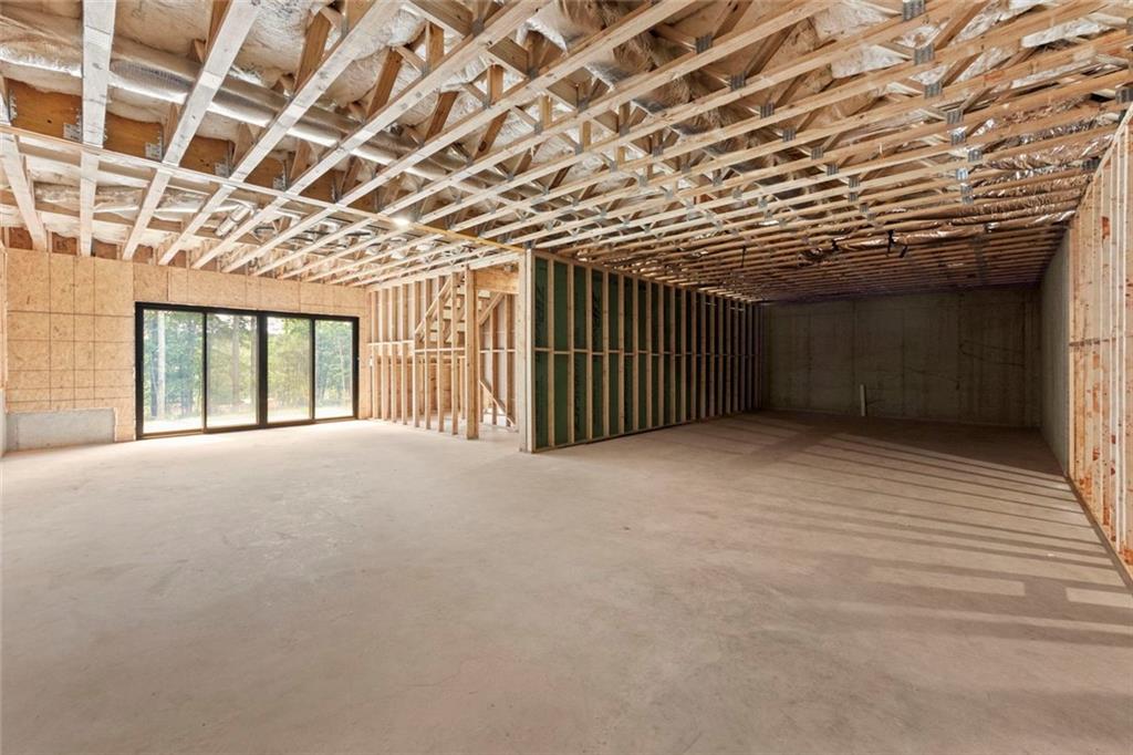 7066 Bells Way Fairburn, GA 30213 - Photo 61 of 64 a view of an empty room with wooden walls