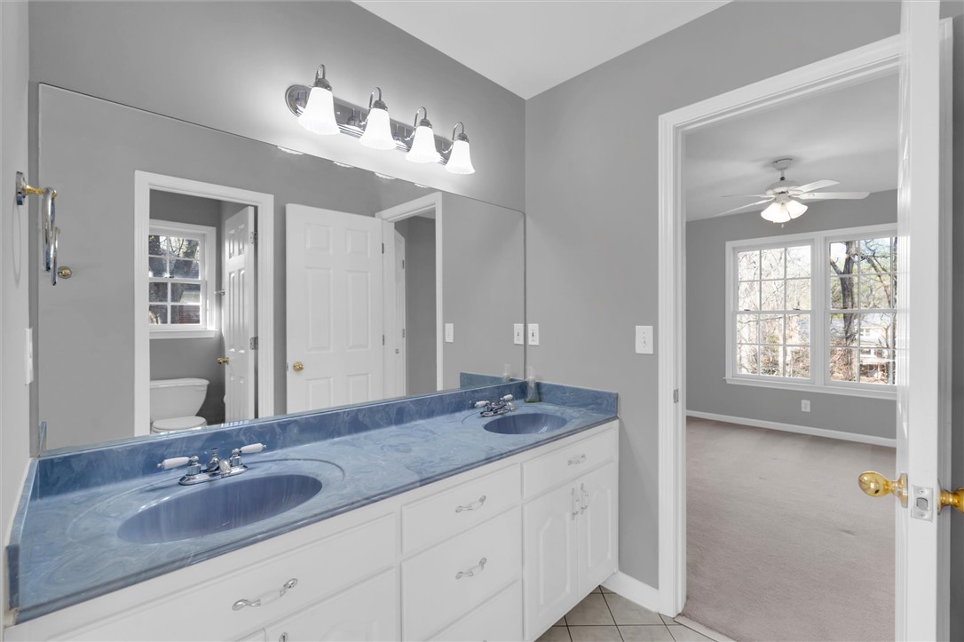 204 Red Maple Way Clemson, SC 29631 - Photo 33 of 48 This primary bathroom features a double vanity and a mirror, with an adjacent room offering ample natural light.