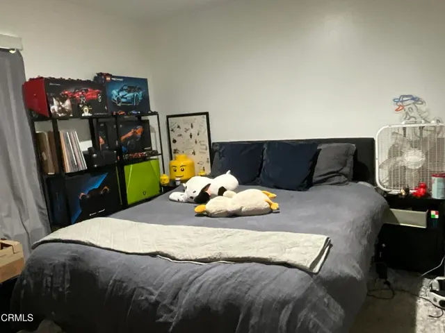 a bedroom with a bed and tv