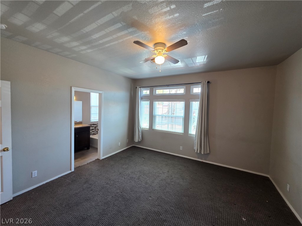2275 Ramsgate Drive Henderson, NV 89074 - Photo 56 of 84 Well-appointed bedroom featuring a ceiling fan and a view into an adjoining bathroom.