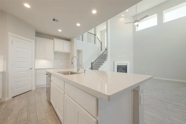 a kitchen with a sink a stove and cabinets