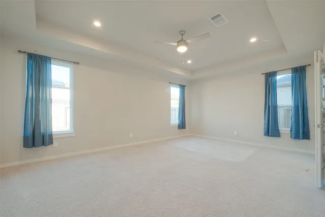 an empty room with windows and closet
