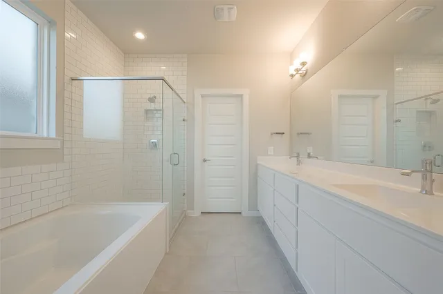a spacious bathroom with a shower sink and mirror