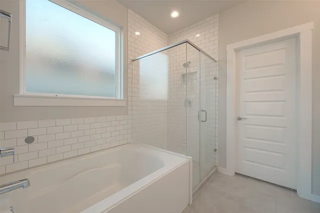 a spacious bathroom with a bathtub and shower
