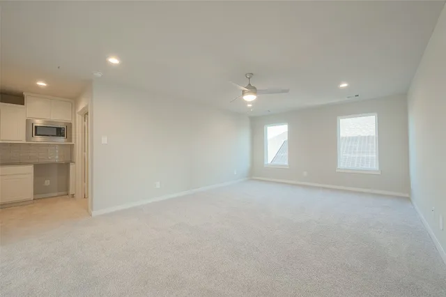 an empty room with windows and closet