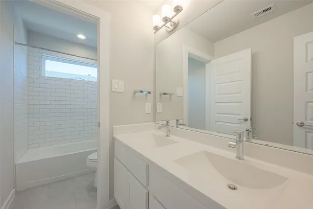 a bathroom with a bathtub and a toilet