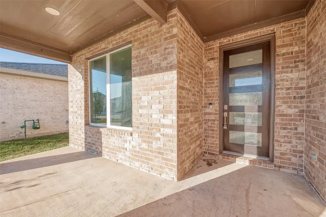 a view of a brick house with outdoor space