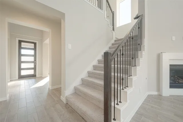 a view of a livingroom with wooden floor and stairs