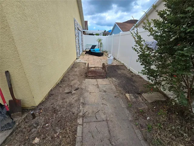 a view of a backyard with sitting area