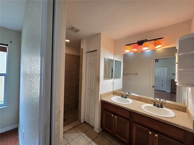 a bathroom with a double vanity sink and mirror