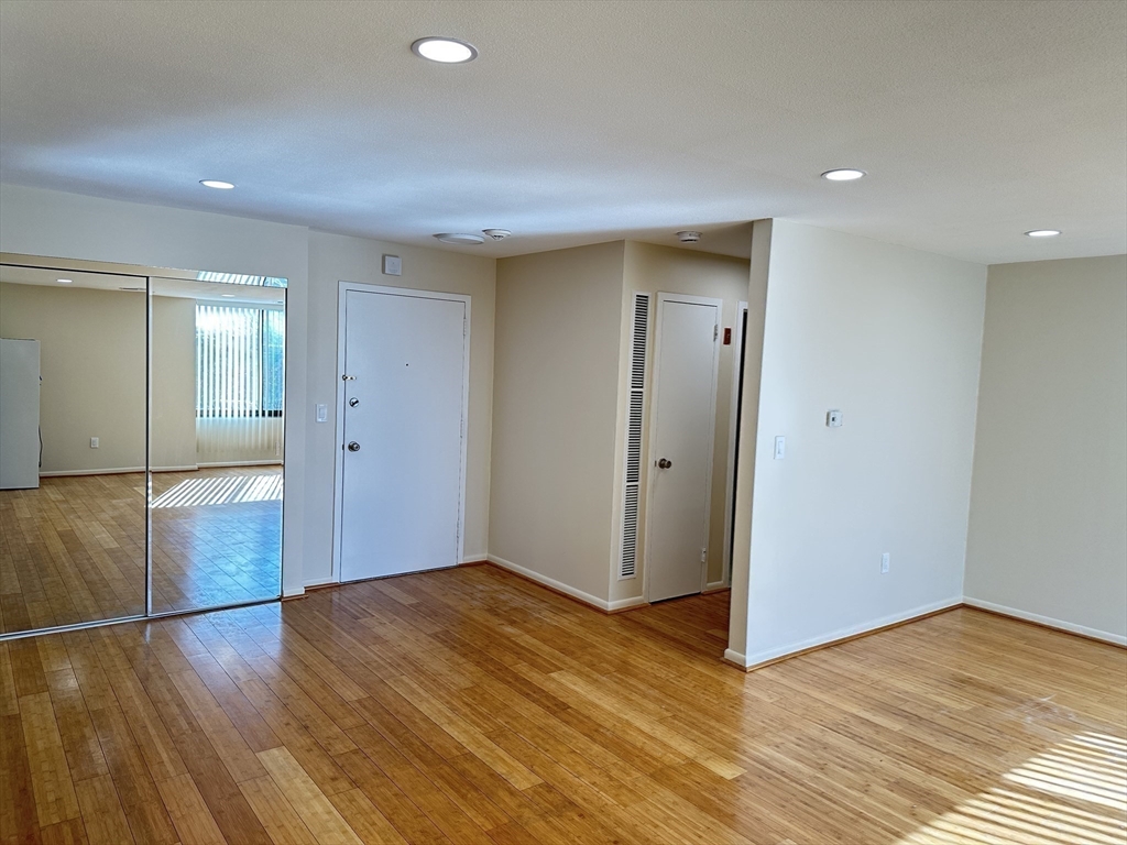 1004 Paradise Road, Unit 1K Swampscott, MA 01907 - Photo 16 of 37 a view of empty room with wooden floor