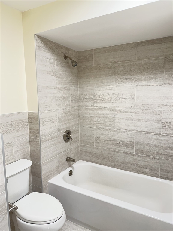 1004 Paradise Road, Unit 1K Swampscott, MA 01907 - Photo 18 of 37 a bathroom with a bathtub and a toilet