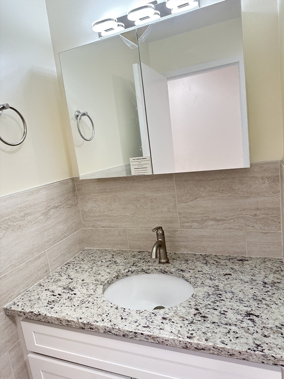 1004 Paradise Road, Unit 1K Swampscott, MA 01907 - Photo 19 of 37 a view of a sink and a mirror