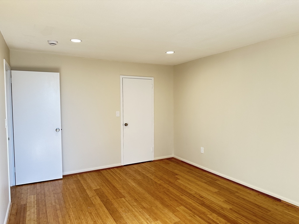 1004 Paradise Road, Unit 1K Swampscott, MA 01907 - Photo 24 of 37 a view of empty room with wooden floor