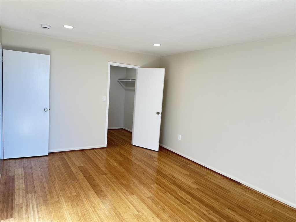 1004 Paradise Road, Unit 1K Swampscott, MA 01907 - Photo 25 of 37 a view of an empty room with wooden floor