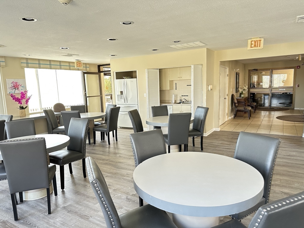 1004 Paradise Road, Unit 1K Swampscott, MA 01907 - Photo 29 of 37 a view of a dining room with furniture and wooden floor