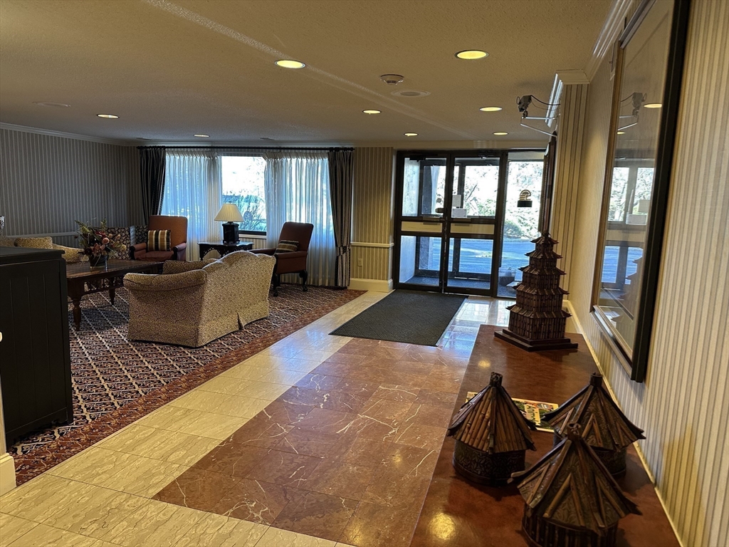 1004 Paradise Road, Unit 1K Swampscott, MA 01907 - Photo 3 of 37 a living room with furniture rug and floor to ceiling window