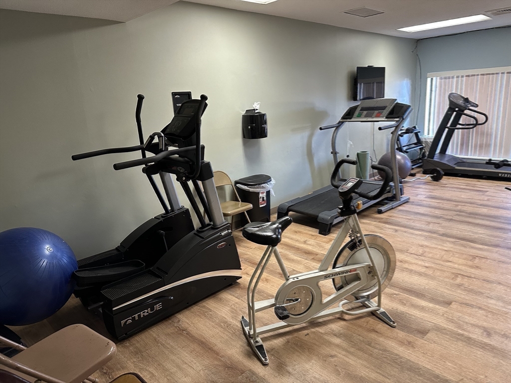 1004 Paradise Road, Unit 1K Swampscott, MA 01907 - Photo 35 of 37 a room with gym equipment and windows