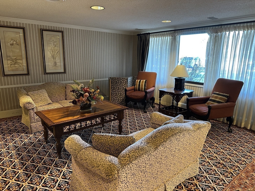 1004 Paradise Road, Unit 1K Swampscott, MA 01907 - Photo 6 of 37 a living room with furniture and wooden floor