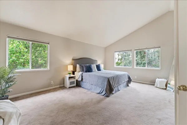 a bedroom with a large bed and a window