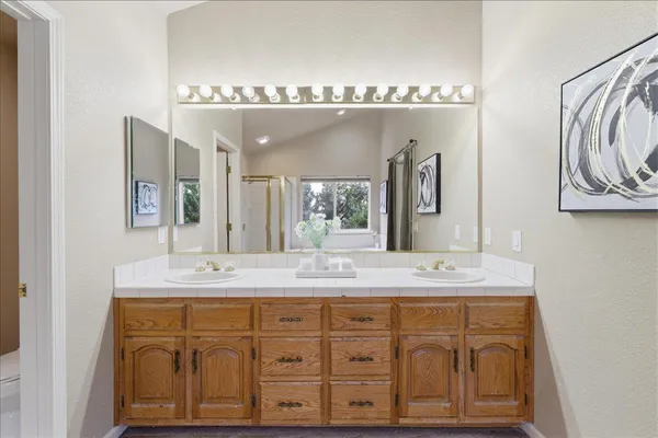 a bathroom with a sink double vanity and a mirror