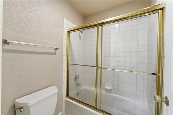 a bathroom with a shower and a toilet