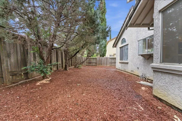 a view of backyard of house with green space