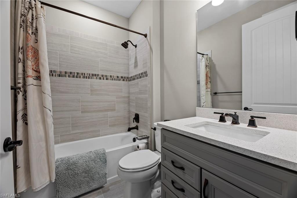 19648 Beechcrest Place Estero, FL 33928 - Photo 16 of 34 a bathroom with a sink a toilet and shower